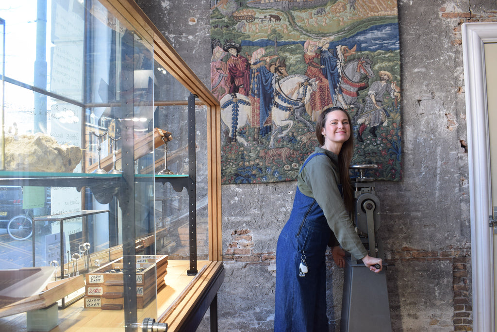 Dutch goldsmith designer Liesbeth Busman in het jewelry store in The Hague with her collection wedding rings in a vintage showcase