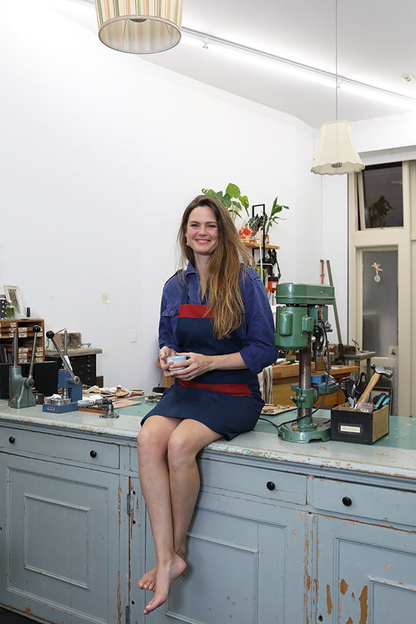 Jewelry designer Liesbeth Busman sitting on her workbench in The Hague. Picture made by Marleen Sleeuwits